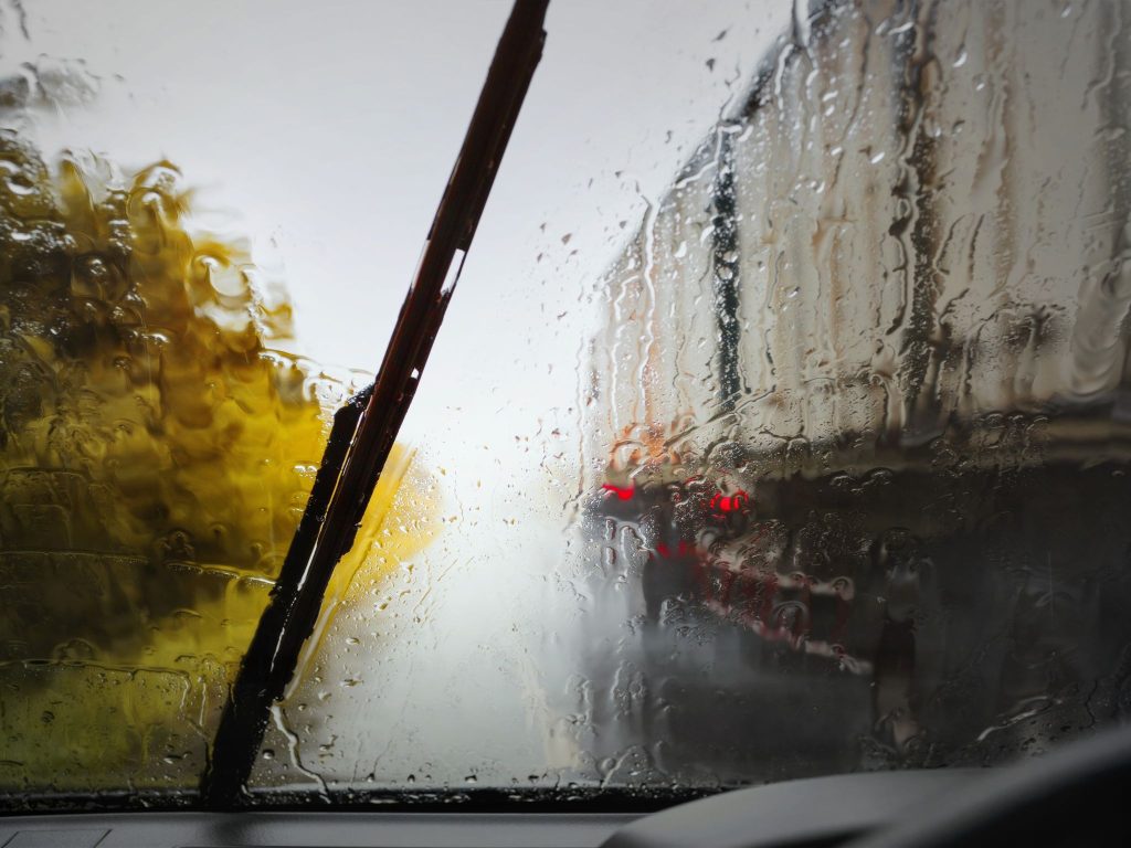 Car driving on a wet road during autumn